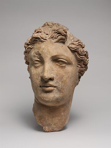 Terracotta head of a woman, probably a sphinx - Greek - Archaic