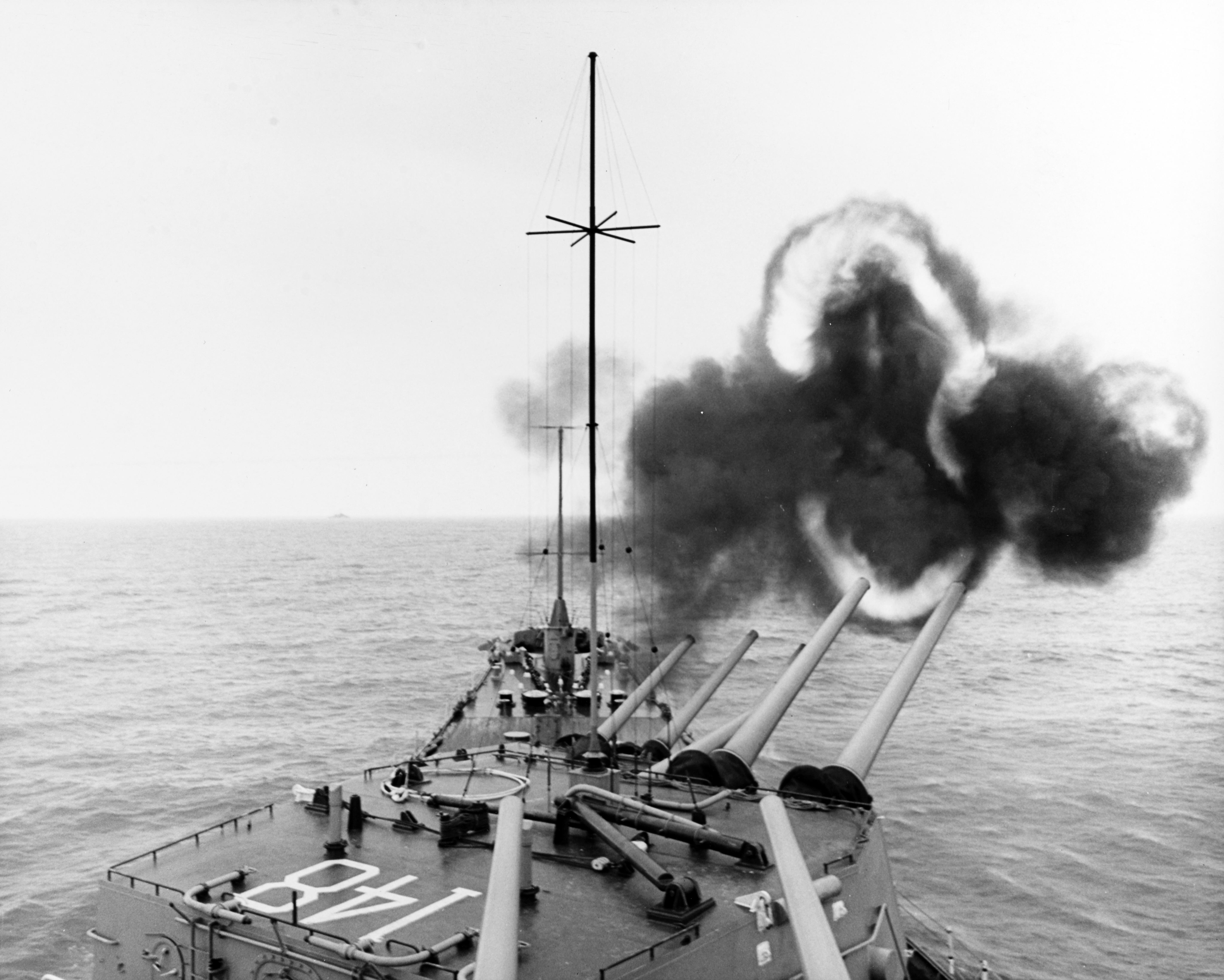 USS Newport News (CA-148) fires her 8-inch/55 caliber guns toward
